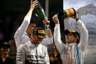 Lewis Hamilton celebrates his win with Mercedes team principal Toto Wolff and Williams' Felipe Massa in the 2013 Abu Dhabi GP (Photo by Mark Thompson/Getty Images)